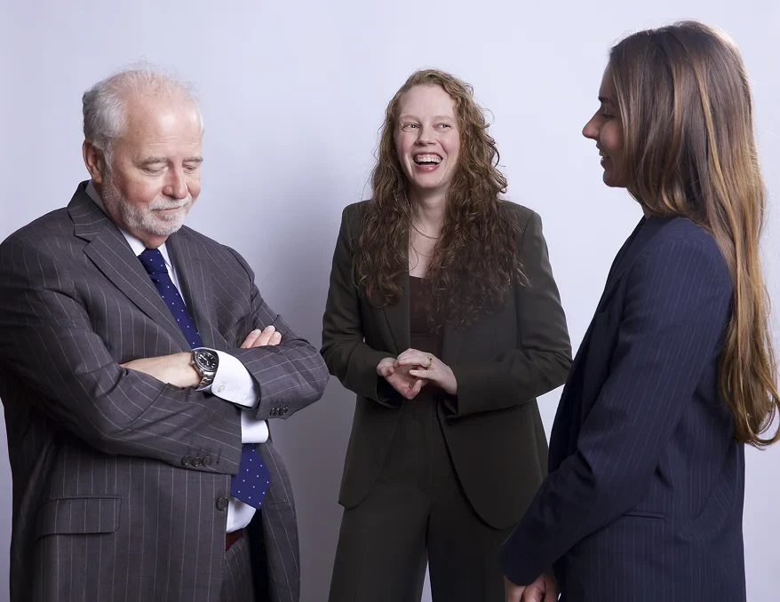 Rob McKinney, Shyanne Riddle, and Savannah standing together in the May McKinney law office